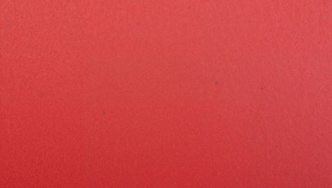Crimson textured wall with fine grain and subtle specks minimalist red gradient background