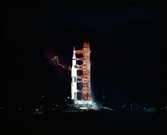 Apollo 15 Saturn V Rocket at Night with Lightning in Background, July 1971 - Download Free Stock Images Pikwizard.com