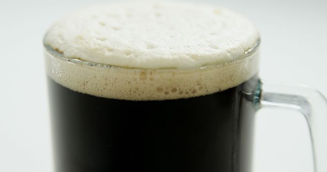 Close-Up of Foamy Dark Beer in a Glass Mug - Download Free Stock Images Pikwizard.com