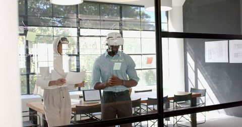 Colleagues collaborating brainstorming with glass board