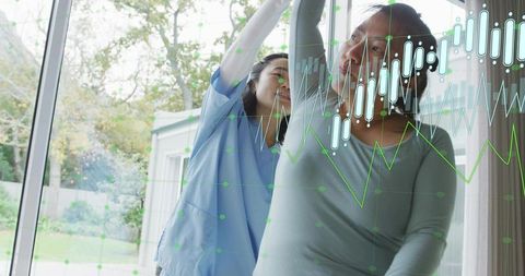 Korean Caregiver Assisting Senior with Arm Rehabilitation, Health Data Overlay