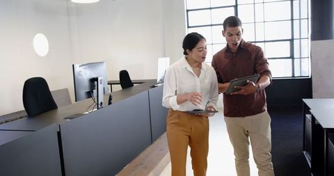 Colleagues Enthusing Over New Project in Modern Office Environment