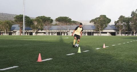 Youth Soccer Player Practicing Dribbling Skills on Field