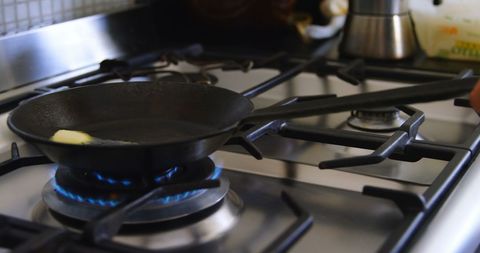 Cooking at Home: Man Preparing Food on Gas Stove - Download Free Stock Images Pikwizard.com