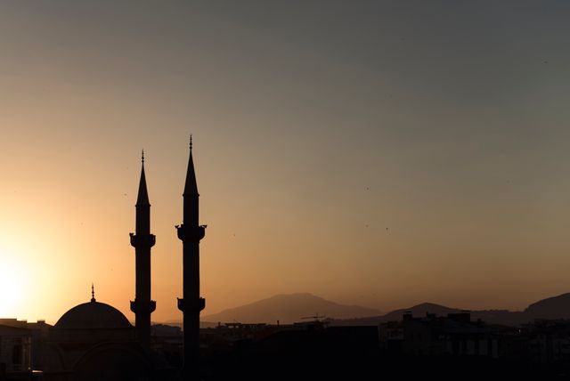Silhouette of Mosque Minarets at Sunset with Scenic Mountain Background - Download Free Stock Photos Pikwizard.com