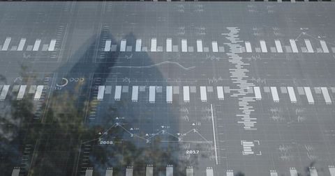 Glass facade reflecting cityscape with financial charts and dynamic data visualization