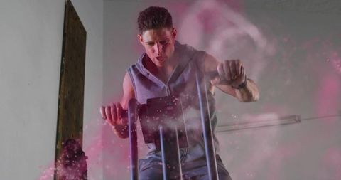 Man Exercising on Elliptical with Pink Powder Swirl in Gym