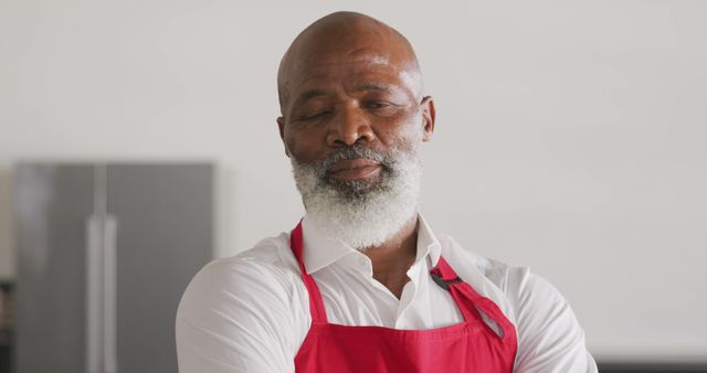 Experienced Chef Relaxing in Kitchen Wearing Red Apron - Download Free Stock Images Pikwizard.com