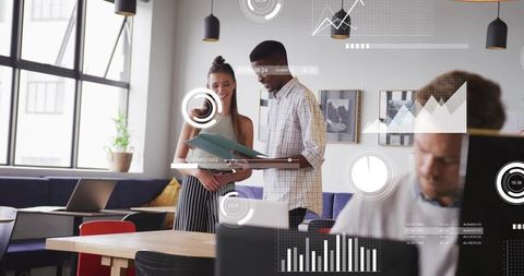 Coworkers reviewing documents and collaborating in modern sunlit office with data overlays