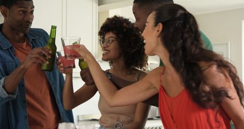Diverse Group of Friends Toasting in Kitchen Ambience