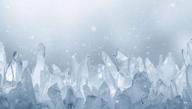 Glittering ice crystal peaks sparkling with falling snow and soft bokeh glow