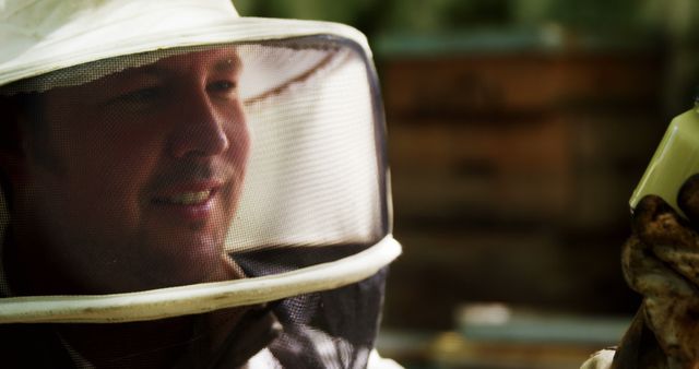 Beekeeper Smiling in Protective Gear at Apiary - Download Free Stock Images Pikwizard.com