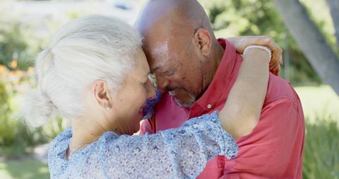 Joyful Senior Couple Dancing Outdoors in Sunny Garden - Download Free Stock Images Pikwizard.com