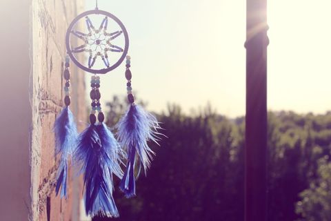 Enchanting blue feather dreamcatcher at sunrise