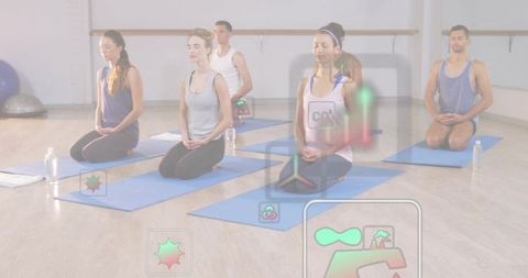 Group meditation class kneeling on blue mats with mindfulness hud overlays in studio