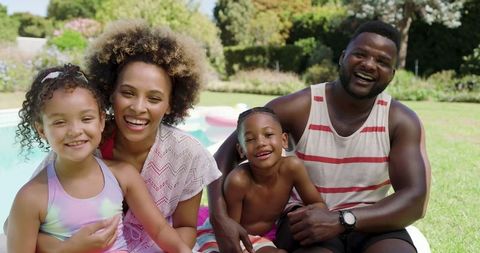 Happy Family Enjoying Summer by Pool Together