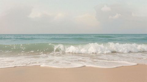 Gentle Waves Lapping at Serene Sandy Beach Shoreline
