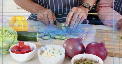Hands slicing cucumber with hud overlay in home kitchen, fresh produce and striped apron