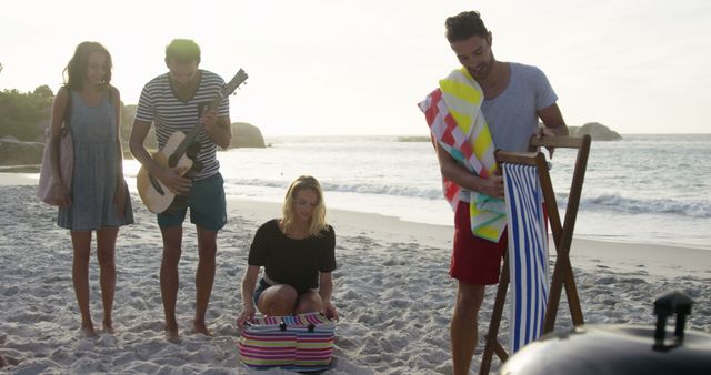 Friends Playing Music and Having Picnic on Beach at Sunset - Download Free Stock Images Pikwizard.com