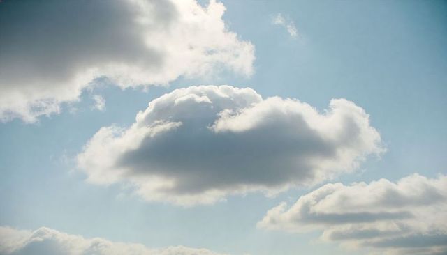 Rising Cumulus Cloud Expanding Over Soft Blue Sky with Fluffy Daylight Atmosphere