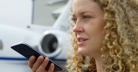 Focused Businesswoman Engaging on Smartphone Call Outdoors