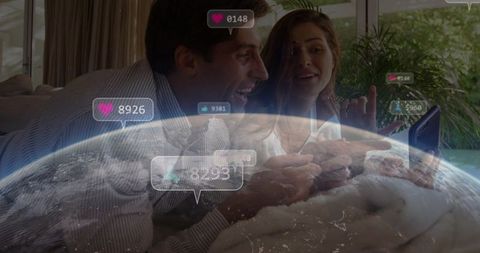 Couple Engaging with Smartphone Overlayed by Earth and Social Icons