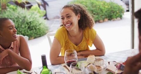 Smiling Friends Enjoy Outdoor Garden Dinner Party