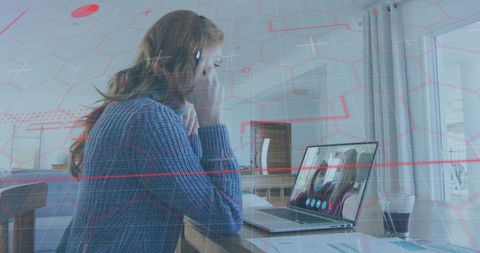 Caucasian woman engaged in virtual meeting at home workspace
