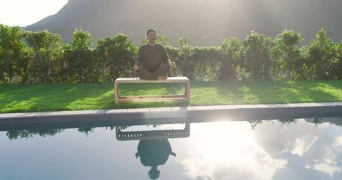 Woman Meditating Beside Pool Reflecting Mountain Serenity