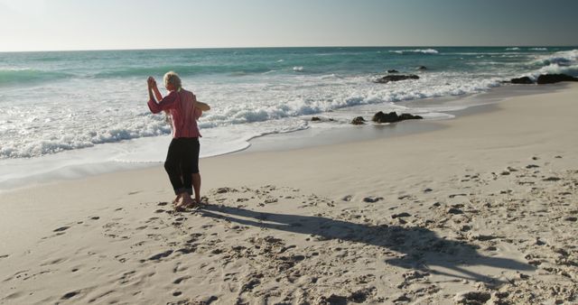 Elderly Couple Dancing on Sandy Beach by Ocean Waves - Download Free Stock Images Pikwizard.com