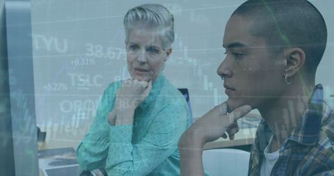 Mother and son analyzing data on computer screen