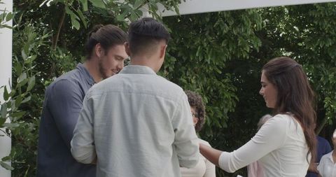 Outdoor wedding celebration with friends enjoying joyful moment