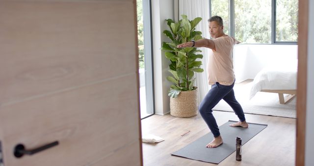 Senior man practicing yoga at home for healthy lifestyle - Download Free Stock Images Pikwizard.com