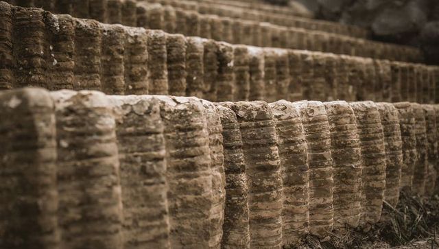 Weathered ribbed stone terraces showing layered striations, banding and textured rockface