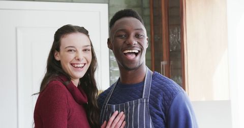 Happy Diverse Couple Laughing Together in Kitchen - Download Free Stock Images Pikwizard.com