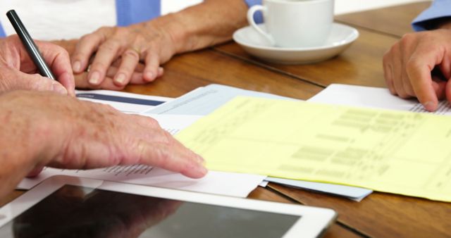 Senior Professionals Handling Paperwork and Finances at Desk - Download Free Stock Images Pikwizard.com