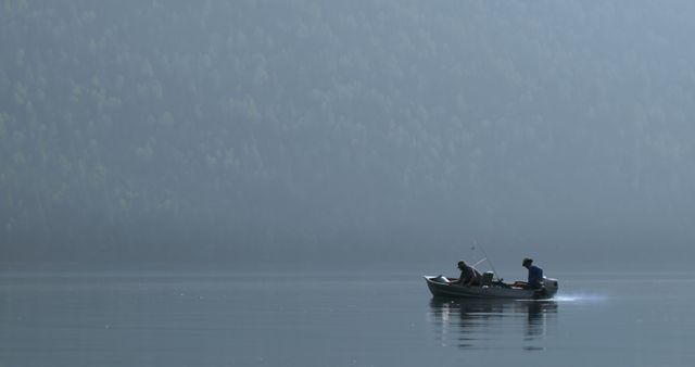 Two Men Fishing on Calm Lake Surrounded by Misty Forest - Download Free Stock Images Pikwizard.com