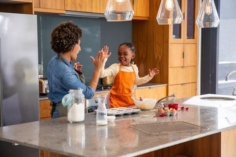Mother and Daughter Baking Joyfully in Modern Kitchen