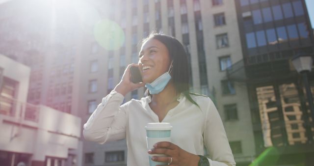 Smiling Woman with Coffee Talking on Phone Outdoors in Urban Area - Download Free Stock Images Pikwizard.com