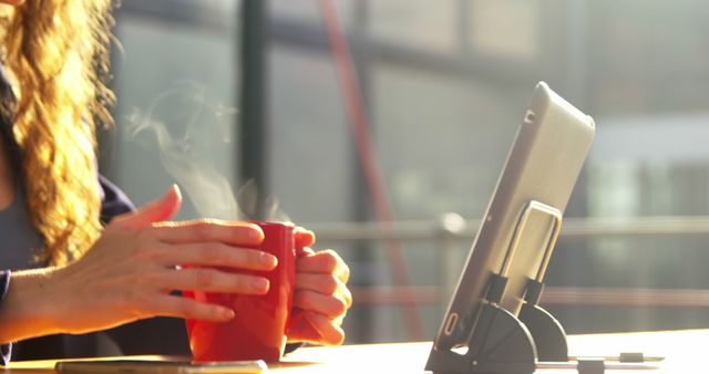 Woman Drinking Coffee and Using Tablet Outdoors on Sunny Day - Download Free Stock Images Pikwizard.com