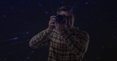 Photographer Taking Aim with Camera in Blue Streaked Studio