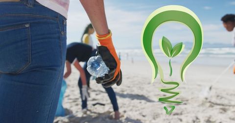 Volunteers cleaning beach with go green logo overlay