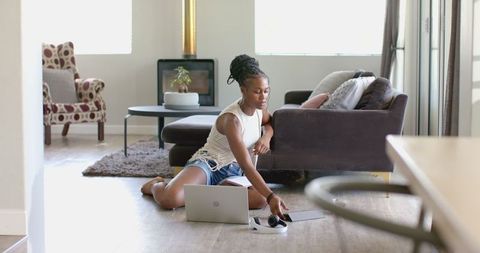 Young Woman Relaxing with Laptop in Casual Home Setting