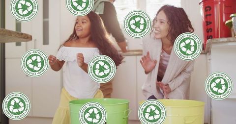 Mother and daughter recycling together at home