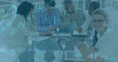 Business team analyzing data with laptops in meeting room