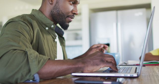 Focused African American Man Working on Laptop at Home - Download Free Stock Images Pikwizard.com