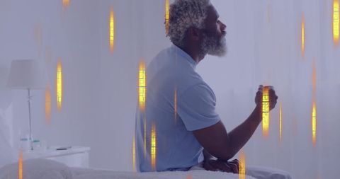 Conceptual technology theme overlaid on pensive biracial man on bed - Download Free Stock Images Pikwizard.com