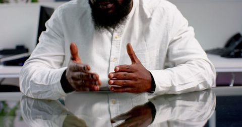 Businessman Gesturing in Meeting at Conference Table