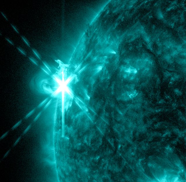 This vibrant teal image shows a powerful M5.7 class solar flare occurring on the sun, captured by NASA’s Solar Dynamics Observatory (SDO) on May 3, 2013. The image specifically highlights the 131 Angstrom wavelength, known for depicting the intense heat of solar flares. Ideal for use in educational materials, space weather monitoring updates, astronomy research presentations, and science articles to illustrate and explain solar phenomena.