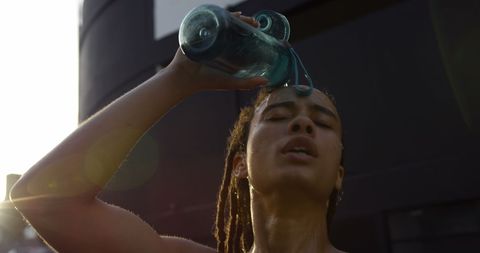 Young Woman Refreshing Outdoors During Workout